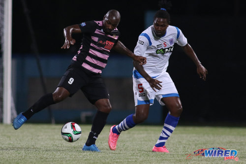 Photo: St Ann's Rangers defender Devon Drayton (right) keeps an eye on Ma Pau Stars forward Jason Scotland during Pro League action at the Ato Boldon Stadium on 18 October 2016. (Courtesy Chevaughn Christopher/Wired868)