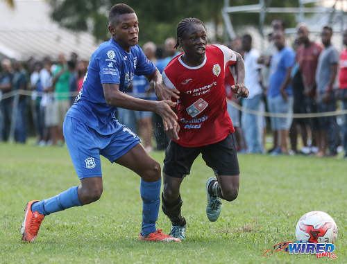 Photo: St Anthony's College midfielder Haile Beckles (right) tries to escape from a Naparima College opponent during SSFL Premier Division action at Westmoorings on 15 October 2016. (Courtesy Sean Morrison/Wired868)