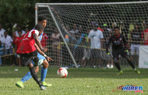 Photo: St Anthony's College midfielder Haile Beckles (left) shoots for goal during SSFL Premier Division action against Naparima College at Westmoorings on 15 October 2016. (Courtesy Sean Morrison/Wired868)