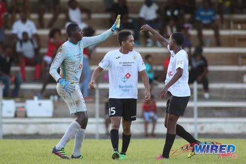 Photo: St Anthony's College defender Nicholas Moyou (centre) and goalkeeper Jabari Brice (left) take a breather during SSFL Premier Division action against Fyzabad on 24 September 2016. (Courtesy Chevaughn Christopher/Wired868)