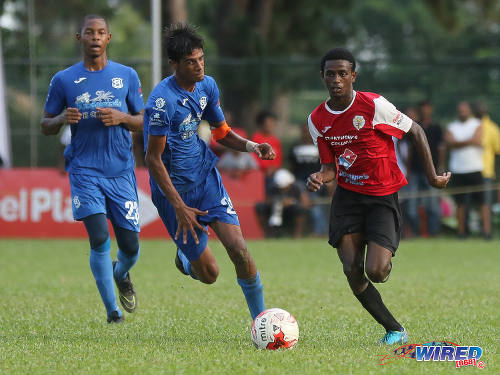 Photo: St Anthony's College winger Tyrese Bailey (right) accelerates past Naparima College midfielder Justin Sadoo (centre) during SSFL Premier Division action at Westmoorings on 15 October 2016. (Courtesy Sean Morrison/Wired868)