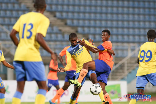 Photo: Defence Force playmaker Hashim Arcia (centre) holds off a Club Sando opponent during First Citizens Cup qualifying action at the Ato Boldon Stadium in Couva on 8 November 2016. (Courtesy Chevaughn Christopher/Wired868)