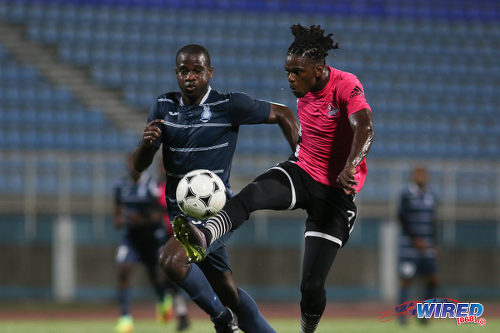 Photo: Central FC attacker Jason Marcano (right) controls the ball under pressure by Police FC defender Elijah Belgrave during Pro League action at the Ato Boldon Stadium on 4 November 2016. (Courtesy Chevaughn Christopher/Wired868)