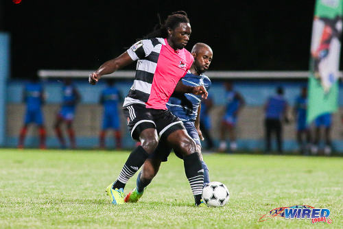 Photo: Central FC forward Kenwyne Jones (left) holds off Police FC defender Dexter Alleyne during Pro League action at the Ato Boldon Stadium on 4 November 2016. (Courtesy Chevaughn Christopher/Wired868)