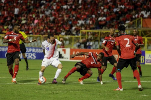 Photo: Costa Rica forward Marcos Ureña (second from left) and Trinidad and Tobago defender Sheldon Bateau (centre) vie for the ball during their 2018 World Cup qualifier football match in Port of Spain, on 11 November 2016. (Copyright AFP 2016/Alva Viarruel)