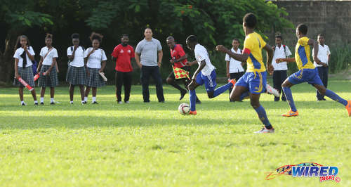 Photo: A Diego Martin North Secondary player (left) scampers down the touchline during North Zone Intercol action against Blanchisseuse Secondary at the St Mary's College ground in St Clair on 2 November 2016. Diego Martin North won 4-1. (Courtesy Sean Morrison/Wired868)