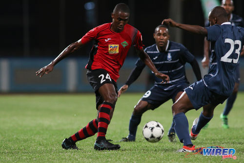 Photo: San Juan Jabloteh defender Adrian Reid (left) tries to force his way past two opponents during Pro League action against Police FC at the Ato Boldon Stadium on 1 November 2016. Jabloteh won 3-2. (Courtesy Chevaughn Christopher/Wired868)