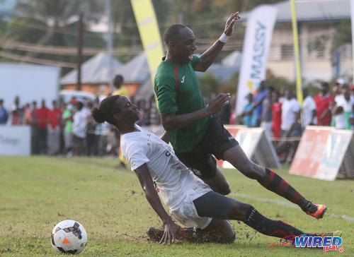 Photo: San Juan Jabloteh utility player Noel Williams (right) is fouled by Morvant Caledonia United forward Sheldon Holder during Pro League action at the Morvant Recreation Ground on 16 October 2016. (Courtesy Sean Morrison/Wired868)