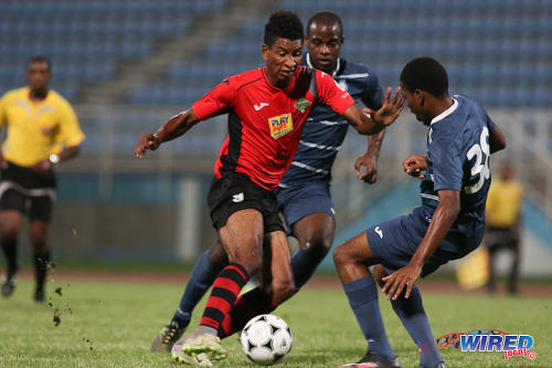 Photo: San Jabloteh striker Willis Plaza (left) takes on Police FC defenders Nequan Caruth (right) and Ryan O'Neil during Pro League at the Ato Boldon Stadium on 1 November 2016. Plaza scored twice as Jabloteh won 3-2. (Courtesy Chevaughn Christopher/Wired868)