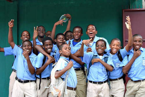 Photo: Students at Belmont Secondary School smile for the cameras during a visit from two-time Olympian Jehue Gordon. (Copyright BBC.co.uk)