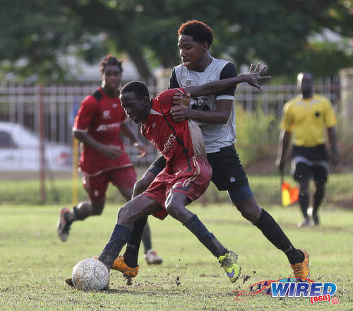 Photo: Trinity College East attacker Dwight Yorke (right) tries to muscle a Malick Secondary opponent off the ball during Championship Big 5 Play Off action in Trincity on 6 November 2016. (Courtesy Sean Morrison/Wired868)