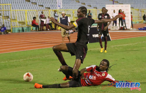 Photo: St Anthony's College defender Ronaldo Jacob (right) tackles East Mucurapo Secondary captain Aquinde Marslin during the North Zone Intercol semifinal at the Hasely Crawford Stadium on 16 November 2016. (Copyright Sean Morrison/Wired868)