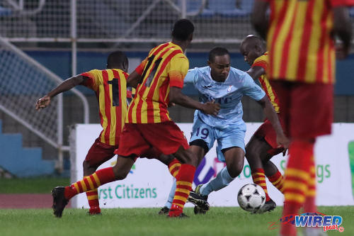 Photo: Police FC attacking midfielder Christon Thomas (centre) takes on the Point Fortin Civic team singlehandedly during First Citizens Cup action at the Ato Boldon Stadium in Couva on 14 November 2016. (Courtesy Chevaughn Christopher/Wired868)