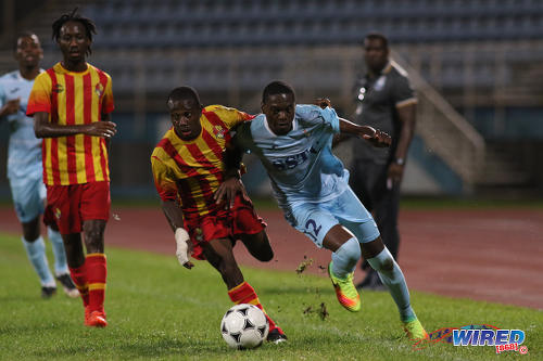 Photo: Police FC winger Kadeem Riley (right) tussles with Point Civic right back Shevhon Abraham (centre) while his teammate Akeem Redhead looks on during First Citizens Cup action at the Ato Boldon Stadium in Couva on 14 November 2016. (Courtesy Chevaughn Christopher/Wired868)