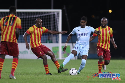 Photo: Police FC attacker Kareem Freitas (centre) tries to keep the ball from Point Fortin Civic midfielder Nickcolson Thomas (second from left) during First Citizens Cup action at the Ato Boldon Stadium in Couva on 14 November 2016. (Courtesy Chevaughn Christopher/Wired868)