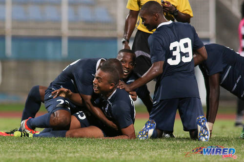 Photo: Police FC midfielder Kenaz Williams (centre) is mobbed by his teammates during Pro League action against W Connection at the Ato Boldon Stadium on 4 November 2016. (Courtesy Chevaughn Christopher/Wired868)