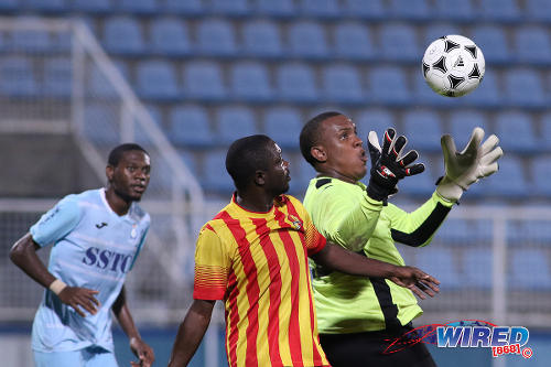 Photo: Police FC goalkeeper Theon Browne (right) tries to catch the ball during First Citizens Cup action against Point Fortin Civic at the Ato Boldon Stadium in Couva on 14 November 2016. (Courtesy Chevaughn Christopher/Wired868)