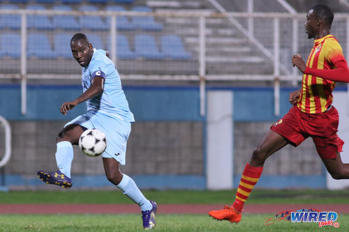 Photo: Police FC captain and midfielder Todd Ryan (left) crosses the ball beyond a Point Fortin Civic player during First Citizens Cup action at the Ato Boldon Stadium in Couva on 14 November 2016. (Courtesy Chevaughn Christopher/Wired868)