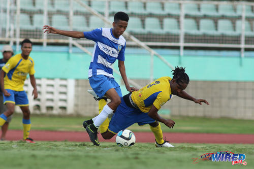 Photo: Presentation College winger Jordan Riley (centre) dribbles past Shiva Boys Hindu College player Shaquille Williams (right) during the South Zone Intercol final at the Mannie Ramjohn Stadium on 18 November 2016. (Courtesy Chevaughn Christopher/Wired868)