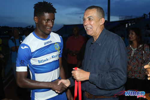 Photo: Presentation College (San Fernando) captain Kareem Riley (left) is congratulated by Trinidad and Tobago President and ex-Pres student Anthony Carmona after their school's 2-1 penalty shootout win over Shiva Boys Hindu College in the 2016 South Zone Intercol final at the Mannie Ramjohn Stadium on 18 November 2016. (Courtesy Chevaughn Christopher/Wired868)