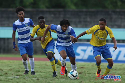 Photo: Presentation College (San Fernando) attacker Nion Lammy (centre) charges at the Shiva Boys Hindu College defence during the South Zone Intercol final at the Mannie Ramjohn Stadium on 18 November 2016. (Courtesy Chevaughn Christopher/Wired868)