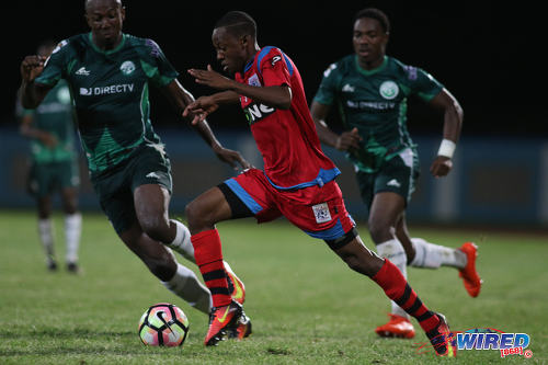 Photo: St Ann's Rangers attacker Jomoul Francois (centre) runs at the W Connection defence during Pro League action at the Ato Boldon Stadium on 4 November 2016. (Courtesy Chevaughn Christopher/Wired868)