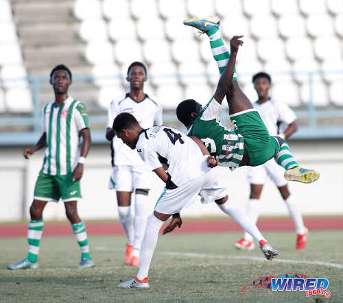 Photo: San Juan North Secondary striker Renaldo Boyce (right) attempts a bicycle kick during the East Zone Intercol final against St Augustine Secondary at the Larry Gomes Stadium, Malabar on 21 November 2016. (Courtesy Annalicia Caruth/Wired868)