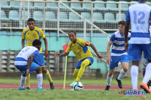 Photo: Shiva Boys Hindu College playmaker and captain Judah Garcia (centre) tries to create space for himself while Presentation College (San Fernando) forward James Alex Lee Yaw (second from right) looks on during the South Zone Intercol final at the Mannie Ramjohn Stadium on 18 November 2016. (Courtesy Chevaughn Christopher/Wired868)