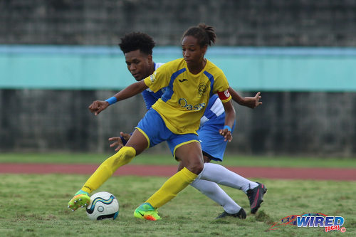 Photo: Shiva Boys Hindu College maestro Tyrel "Pappy" Emmanuel (right) tries to shake off Presentation College (San Fernando) midfielder Terrell Williams during the South Zone Intercol final at the Mannie Ramjohn Stadium on 18 November 2016. (Courtesy Chevaughn Christopher/Wired868)