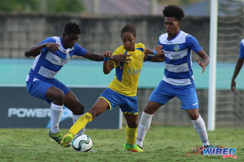 Photo: Shiva Boys Hindu College maestro Tyrel "Pappy" Emmanuel (centre) tries to hold off Presentation College (San Fernando) midfielders Kareem Riley (left) and Terrell Williams during the South Zone Intercol final at the Mannie Ramjohn Stadium on 18 November 2016. (Courtesy Chevaughn Christopher/Wired868)