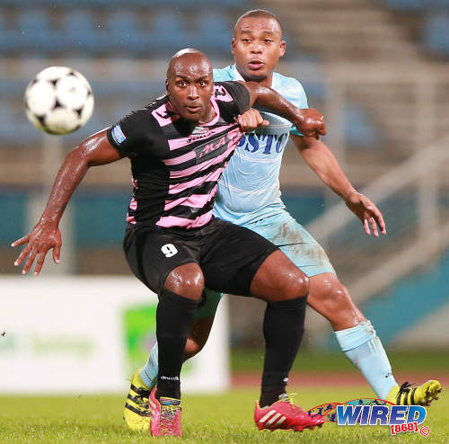 Photo: Ma Pau Stars striker Jason Scotland (left) holds off Police FC midfielder Kenaz Williams in the First Citizens Cup semifinal on 27 November 2016. (Courtesy Allan V Crane/Wired868)