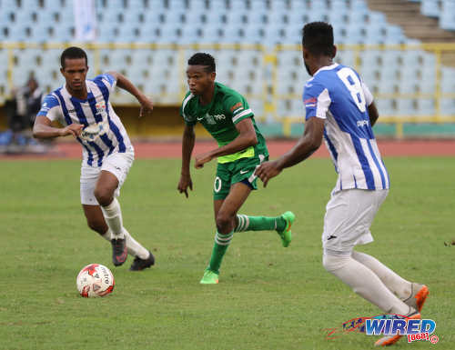 Photo: Trinity College midfielder Isiah McClean (centre) looks for space between St Mary's College players Aaron Skeene (left) and Matthaeus Granger during the North Zone Intercol semifinal at the Hasely Crawford Stadium on 16 November 2016. (Copyright Sean Morrison/Wired868)