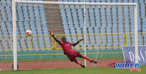 Photo: Trinity College (Moka) goalkeeper Desean Bowen dives in vain after a penalty during the North Zone Intercol semifinal against St Mary's College at the Hasely Crawford Stadium on 16 November 2016. (Copyright Sean Morrison/Wired868)