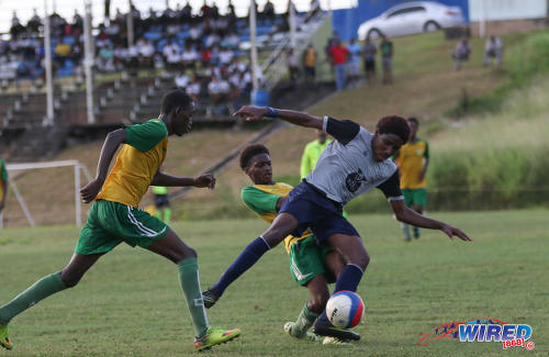 Photo: Trinity College East forward Dwight Yorke (right) tries to keep possession during SSFL Championship Big 5 PlayOff action away to Princes Town West Secondary on 4 November 2016. (Courtesy Sean Morrison/Wired868)