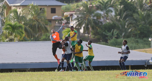 Photo: Trinity College East goalkeeper Emmanuel John (left) stretches for a high ball during SSFL Championship Big 5 PlayOff action away to Princes Town West Secondary on 4 November 2016. (Courtesy Sean Morrison/Wired868)