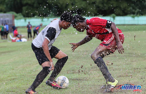 Photo: Trinity College East attacker Kishon Hackshaw (left) tries to evade Malick Secondary captain and defender Brandon Charles during Championship Big 5 Play Off action in Trincity on 6 November 2016. (Courtesy Sean Morrison/Wired868)