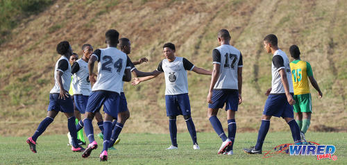 Photo: Trinity College East midfielder Kishon Hackshaw (centre) accepts the congratulations of his teammates during SSFL Championship Big 5 PlayOff action away to Princes Town West Secondary on 4 November 2016. (Courtesy Sean Morrison/Wired868)