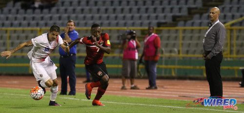 Photo: Trinidad and Tobago winger Cordell Cato (centre) tussles with Costa Rica right wing back Christian Gamboa while T&T coach Stephen Hart looks on during Russia 2018 World Cup qualifying action at the Hasely Crawford Stadium on 11 November 2016. (Courtesy Sean Morrison/Wired868)