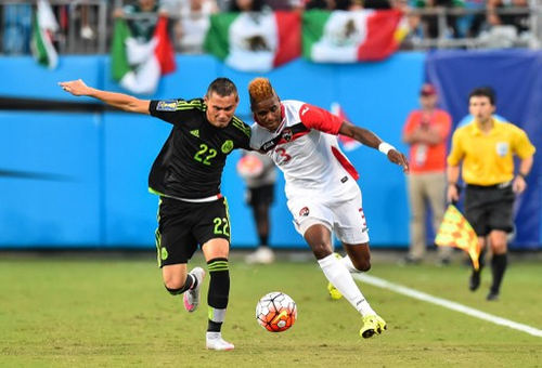 Photo: Trinidad and Tobago winger Joevin Jones (right) battles with Mexico midfielder Paul Aguilar during a 2015 CONCACAF Gold Cup Group C match in Charlotte, North Carolina, on 15 July 2015. (Copyright AFP 2016/Nicholas Kamm)