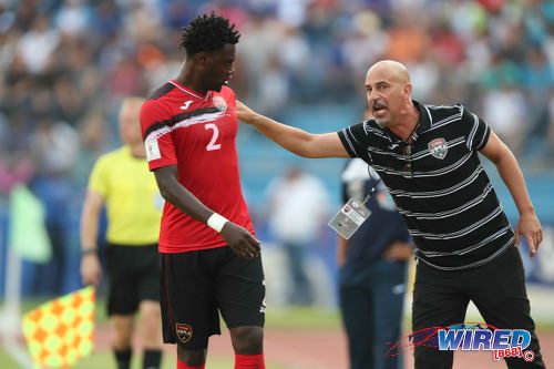 Photo: Trinidad and Tobago coach Stephen Hart (right) passes on instructions to left back Aubrey David during 2018 World Cup qualifying action against Honduras in San Pedro Sula on 15 November 2016. (Courtesy Allan V Crane/Wired868)