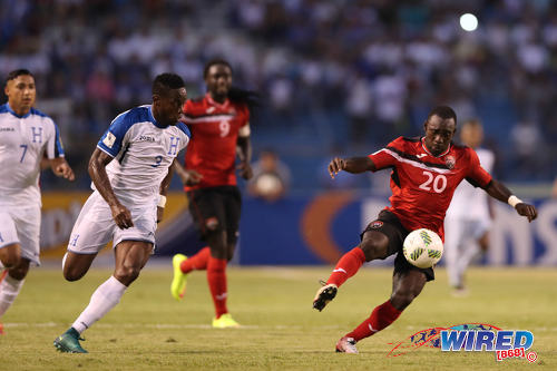 Photo: Trinidad and Tobago forward Trevin Caesar (right) tries to escape the attentions of Honduras defender Maynor Figueroa during 2018 World Cup qualifying action in San Pedro Sula on 15 November 2016. (Courtesy Allan V Crane/Wired868)