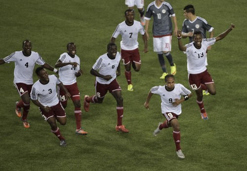 Photo: Trinidad and Tobago's Nathaniel Garcia (second from right) celebrates with teammates after scoring against Paraguay during the 2015 Pan American Games in Hamilton, Canada on 17 July 2015. (Copyright AFP 2016/Omar Torres)