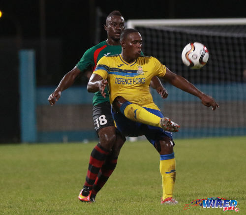 Photo: Defence Force striker Devorn Jorsling (right) cushions the ball while San Juan Jabloteh defender Jevon Morris stands guard during Pro League action at the Ato Boldon Stadium on 18 September 2016. (Courtesy Sean Morrison/Wired868)