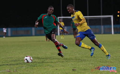 Photo: Defence Force playmaker Hashim Arcia (right) attempts to glide past San Juan Jabloteh defender Jerome Isaiah McIntyre during Pro League action at the Ato Boldon Stadium on 18 September 2016. (Courtesy Sean Morrison/Wired868)