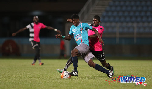 Photo: Morvant Caledonia United flanker Jameel Neptune (left) tries to evade Central FC midfielder Kishun Seecharan during Pro League action at the Ato Boldon Stadium in Couva on 20 December 2016. (Courtesy Chevaughn Christopher/Wired868)