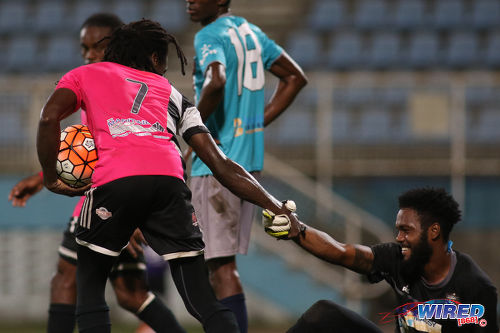 Photo: Central FC attacker Jason Marcano (left) offers Morvant Caledonia United goalkeeper Stephon Seepersad a hand during Pro League action at the Ato Boldon Stadium in Couva on 20 December 2016. (Courtesy Chevaughn Christopher/Wired868)