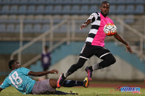 Photo: Central FC substitute Johan Peltier (right) shrugs off a challenge from Morvant Caledonia United defender Maestro Mensah en route to scoring his team's opener during Pro League action at the Ato Boldon Stadium in Couva on 20 December 2016. (Courtesy Chevaughn Christopher/Wired868)