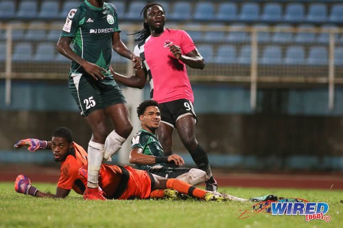 Photo: Central FC forward Kenwyne Jones watches his neat chipped effort nestle into the back of the net while W Connection goalkeeper Terrence Lewis (left) and Alvin Jones look on during Pro League action at the Ato Boldon Stadium in Couva on 12 December 2016. (Courtesy Chevaughn Christopher/Wired868)