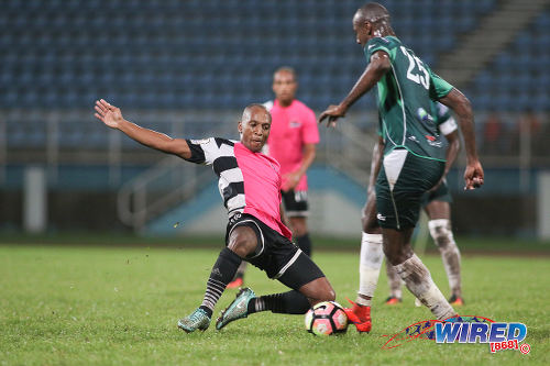 Photo: Central FC midfielder Leston Paul (left) flies into a tackle against W Connection defender Daneil Cyrus during Pro League action at the Ato Boldon Stadium in Couva on 12 December 2016. (Courtesy Chevaughn Christopher/Wired868)