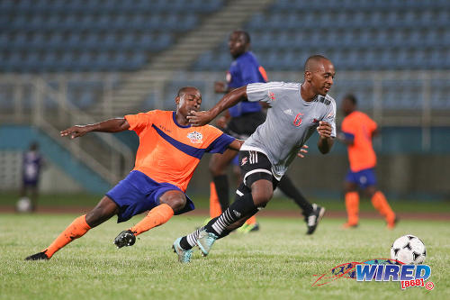 Photo: Central FC midfielder Leston Paul (right) looks to escape from a Club Sando opponent during Pro League action at the Ato Boldon Stadium on 16 December 2016. (Courtesy Chevaughn Christopher/Wired868)